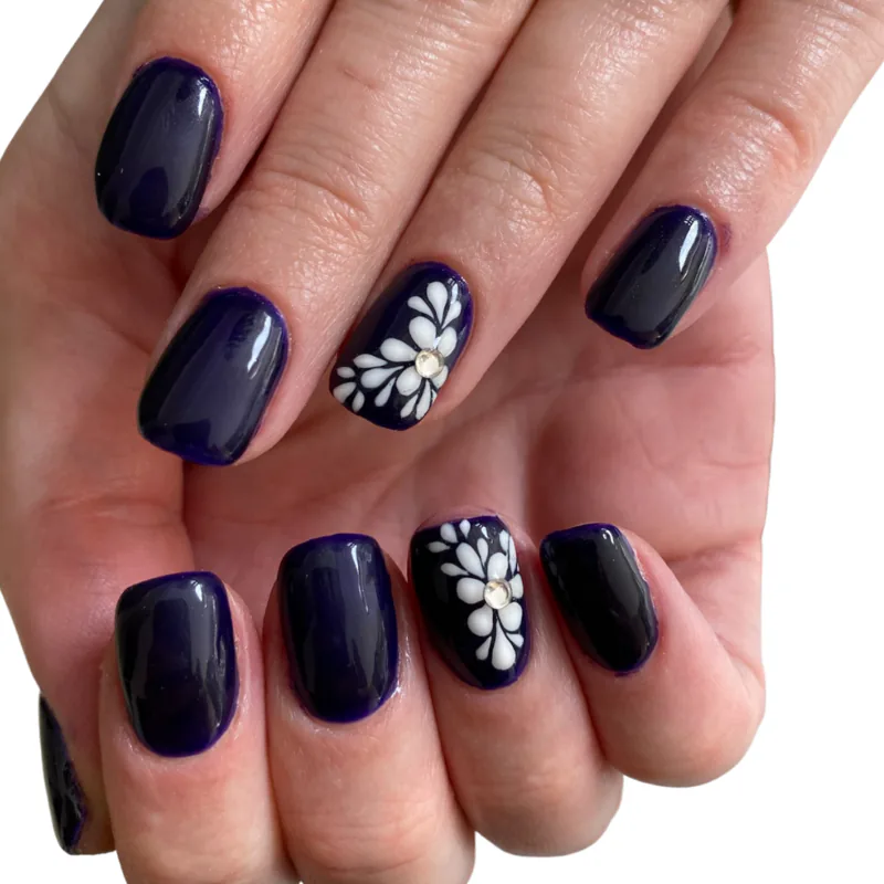 black nails with white flower nail art