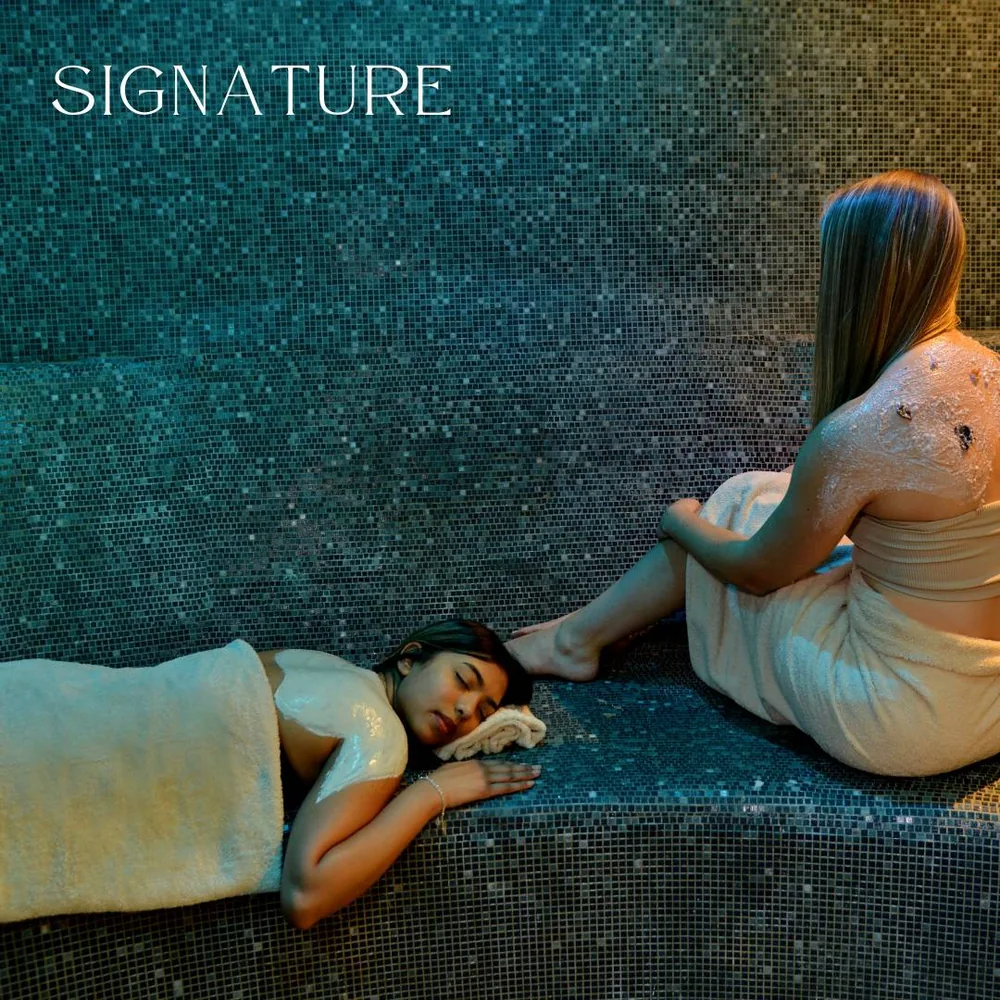 signature spa package women relaxing on heated lounger