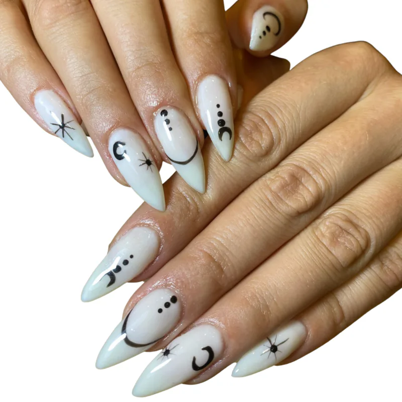 white stiletto nails with moon and star art